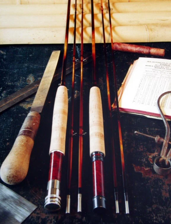 Finished Wagner rod sections laid side by side, showing wraps, ferrules and the flamed cane.