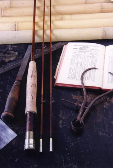 Fine silk wraps with black tipping on a flamed cane rod section.
